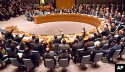 FILE - A gathering in the U.N. Security Council of foreign ministers lead by U.S. Secretary of State John Kerry vote on a draft resolution concerning Syria, at U.N. headquarters, Dec. 18, 2015.