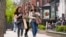 FILE - Pedestrians walk along Boston's fashionable Newbury Street, May 2, 2021. The CDC said Thursday that fully vaccinated people can safely stop wearing masks in most indoor and outdoor settings.