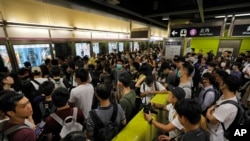 Passengers line up at a subway platform in Hong Kong on Tuesday, July 30, 2019. (AP)