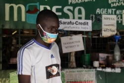 Shop owner Peter Odhiambo's store is one of 100 food stores that accept Sarafu, a community initiative currency developed by Grassroots Economics and U.S.-based engineering firm BlockScience. (Mohammed Yusuf/VOA)