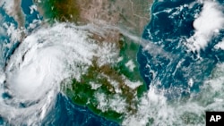 This satellite image provided by the National Oceanic and Atmospheric Administration shows Hurricane Olaf on the Pacific coast of Mexico approaching the Los Cabos resort region, early on Sept. 9, 2021.