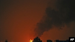 Fire and smokes erupt during clashes between tribesmen loyal to Sheik Sadeq al-Ahmar, the head of the powerful Hashid tribe, and Yemeni security forces in Sanaa, Yemen, late Thursday, June 2, 2011
