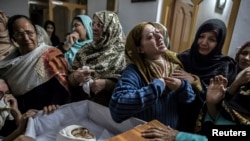 FILE - A mother mourns her son Mohammed Ali Khan, 15, a student who was killed during an attack by Taliban gunmen on the army-administered Public School, at her house in Peshawar, December 16, 2014.