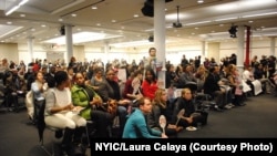 Members of the New York Immigration Coalition watch President Barack Obama's televised speech about his executive order, Nov. 20, 2014.