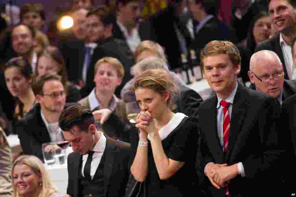 People react as a television promoter announce results of the United States elections during a Presidential Election party hosted by the United States embassy and German Telekom in Berlin, Germany.