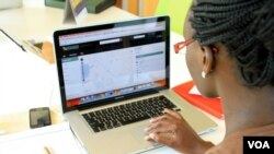 A woman looks at the Uchaguzi Web site at the iHub, Nairobi, Kenya, Feb. 28, 2013. (J. Craig/VOA)