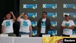 Revolutionary Armed Forces of Colombia (FARC) commander Ivan Marquez receives applause from Carlos Lozada, Pablo Catatumbo and Joaquin Gomez during a news conference at the camp where they later ratified a peace deal with the Colombian government, near El