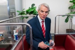 Sen. Rob Portman, R-Ohio, talks to reporters as he takes a Senate subway train on Capitol Hill in Washington, July 30, 2021.