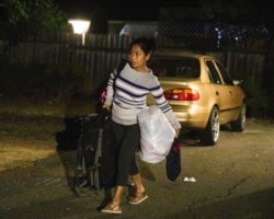 Eve Peteros helps evacuate Redwood Retreats, a residential care facility in Santa Rosa, Calif., Oct. 26, 2019. A Northern California blaze forced evacuation orders and warnings for nearly all of Sonoma County.