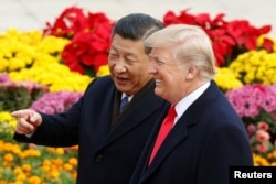 FILE - U.S. President Donald Trump and China's President Xi Jinping attend a welcoming ceremony in Beijing, Nov. 9, 2017.