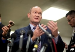 Sen. Chris Coons, a Delaware Democrat, gestures while speaking to reporters on Capitol Hill in Washington, Nov. 28, 2018.