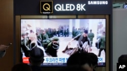 FILE - A TV screen shows an image of soldiers believed to be from North Korea standing in line to receive supplies from Russia during a news program at Seoul Railway Station in Seoul, South Korea, Oct. 21, 2024.