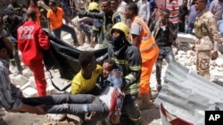 Rescuers carry away a man who was injured by a blast in the Somali capital of Mogadishu, Feb. 4, 2019.