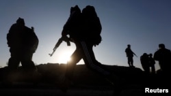 Afghan security forces arrive at the site of truck blast in Kabul, Afghanistan, Nov. 18, 2014.