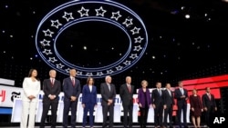From left, Tulsi Gabbard, Tom Steyer, Cory Booker, Kamala Harris, Bernie Sanders, Joe Biden, Elizabeth Warren, Pete Buttigieg, Andrew Yang, Beto O'Rourke, Amy Klobuchar and Julian Castro are pictured before debating in Westerville, Ohio, Oct. 15, 2019.