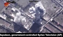This image made from video of drone footage allegedly showing Syrian army airstrikes targeting Zahran Allouch, the head of the Army of Islam group near Damascus, Syria, Dec. 25, 2015.
