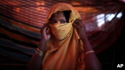 FILE - This 22-year-old mother of one, who did not want her name used, says she was raped by members of Myanmar's armed forces in late August. She is photographed in her tent in the Gundum refugee camp in Bangladesh, Nov. 23, 2017.