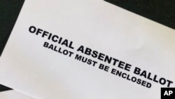 A Cobb County Ga., absentee ballot is seen Tuesday, May 5, 2020, in Kennesaw, Ga. Presidential Preference Primary, General Primary Election, Nonpartisan General Election, and Special Election will be held June 9, 2020.