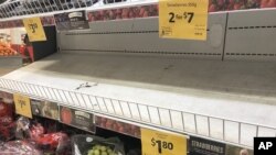 Empty shelves, normally stocked with strawberry punnets, are seen at a Coles Supermarket in Brisbane, Australia, Sept. 14, 2018.