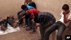 Detained immigrants are housed inside the McAllen Border Patrol Station in McAllen, Texas, Tuesday July 15, 2014. 