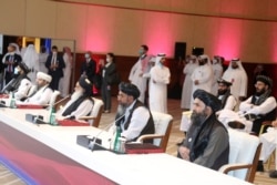 The Taliban delegation attends the opening session of peace talks between the Afghan government and the Taliban, in Doha, Qatar, Sept. 12, 2020.