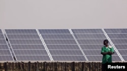 FILE - Solar panels are seen during the inauguration ceremony of the solar energy power plant in Zaktubi, near Ouagadougou, Burkina Faso, Nov. 29, 2017. 