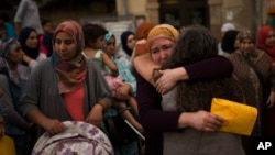 Members of the local Muslim community gather along with relatives of young men believed responsible for the attacks in Barcelona and Cambrils to denounce terrorism and show their grief in Ripoll, north of Barcelona, Spain, Aug. 20, 2017.