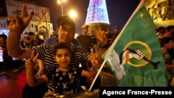 Supporters of Iraqi Shiite cleric Moqtada al-Sadr celebrate in Baghdad's Tahrir square on Oct. 11, 2021, following the announcement of parliamentary elections' results.
