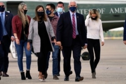 Vice President Mike Pence and his wife Karen, along with Sarah Pence and her husband Michael Pence and their daughter, right, arrive on Marine Two at Andrews Air Force Base, Md., Oct. 5, 2020, as he departs for Utah.