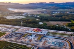 In this photo released by Xinhua News Agency, an aerial view shows Ganlanba railway station, one of the stations along the China-Laos railway, under construction Sept. 28, 2021, in China's southwestern Yunnan province.