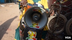 Ibrahim Sacko, a traveling storyteller, tours around Kayes on his motorbike to spread awareness on Ebola. His most important message is for people to wash their hands, Kayes, Mali, Nov. 6, 2014. (Katarina Höije)