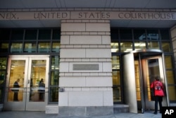 People enter the Federal Court, Oct. 30, 2017, in Washington.