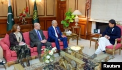 Pakistani Prime Minister Imran Khan, right, speaks with U.S. special envoy Zalmay Khalilzad, third from left, during a meeting at the Prime Minister's office in Islamabad, Pakistan, in this handout photo released Jan. 18, 2018.