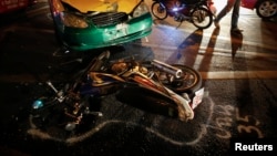 FILE - The positions of colliding vehicles are marked at the site of a road accident during the Songkran festival in Bangkok, Thailand.