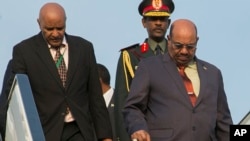 Sudan President Omar al-Bashir, right, arrives in Kigali, Rwanda, July 16, 2016, to attend an African Union summit. He defied an international arrest warrant after public assurances from Rwandan leaders that he would not be arrested. He is wanted by the ICC for alleged atrocities in his country's Darfur region.