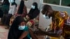 FILE - A health worker administers a dose of the Johnson & Johnson COVID-19 vaccine at the Bundung Maternal and Child Health Hospital, in Serrekunda, outskirts of Banjul, Gambia, Sept. 23, 2021. 