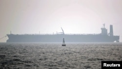 FILE - An oil tanker is seen in the Persian Gulf, May 27, 2006. Authorities said Jan. 1, 2021, that a crew was being evacuated from an oil tanker in the waters off the Iraqi port of Basra after a limpet mine was found on the side of the ship.