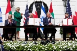 FILE - Bahrain’s FM Abdullatif al-Zayani, Israel's PM Benjamin Netanyahu, US President Donald Trump and United Arab Emirates (UAE) FM Abdullah bin Zayed participate in the signing of the Abraham Accords, at the White House, Sept. 15, 2020.