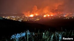 Buildings burn as a wind-driven grass fire destroys hundreds of homes, displaces thousands, as seen from Denver, Colorado, U.S. December 30, 2021. (Gregg Corella/Handout via REUTERS)