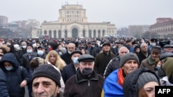 Armenian opposition supporters rally demanding the resignation of Prime Minister Nikol Pashinyan over a controversial peace deal with Azerbaijan that ended six weeks of war over the disputed region of Nagorno-Karabakh, in Yerevan, Dec. 22, 2020.