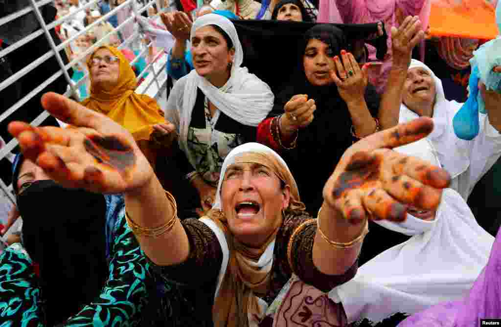 Kashmiri Muslim women pray during a festival to mark the death anniversary of Usman ibn Affan, one of the companions of Mohammed, at the Hazratbal Shrine in Srinagar, India.
