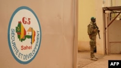 FILE - A Malian Army soldier with the G5 Sahel, an institutional framework for coordination of regional cooperation in development policies and security matters in West Africa, is seen in Sevare, May 30, 2018.