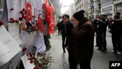A man reacts in front of a makeshift memorial at the location of the blast of a suicide attack on Istiklal Street, a major shopping and tourist district, in central Istanbul, March 20, 2016.