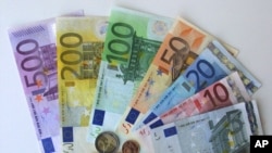 FILE- Photo shows euro currency in the regional central bank in Bremen, Germany, Dec. 14, 2001. Italian police said they had seized assets worth 2 billion euros ($2.2 billion) and issued 41 arrest warrants in raids on gambling companies in Italy and abroad run by the 'Ndrangheta mafia organization.