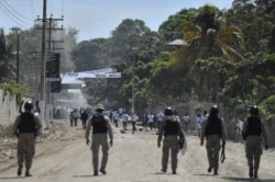 upporters of slain Haitian President Jovenel Moise are blocked by security forces from attending Moise's funeral outside the former leader's family home in Cap-Haitien, Haiti, July 23, 2021.