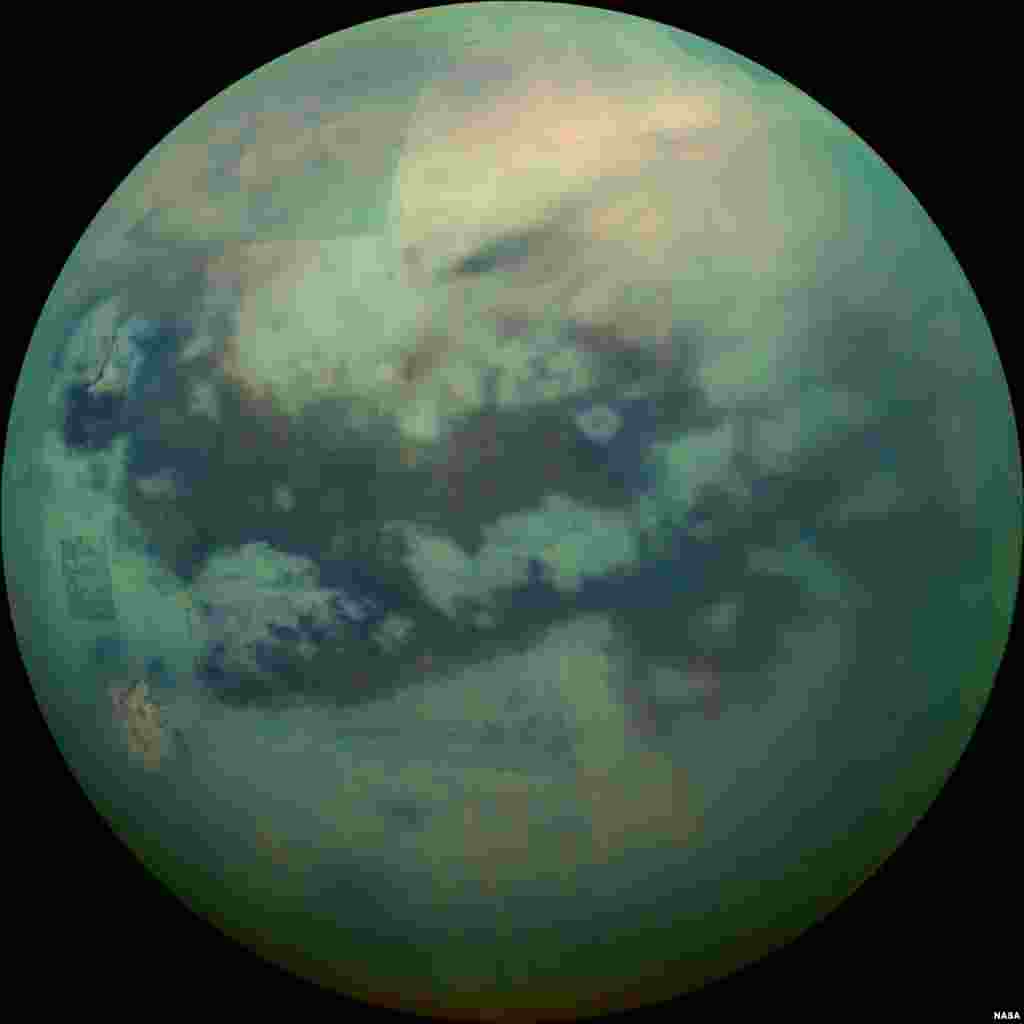 This Nov. 13, 2015 composite image made available by NASA shows an infrared view of Saturn's moon, Titan, as seen by the Cassini spacecraft. The near-infrared wavelengths in this image allow the cameras to penetrate the haze and reveal the moon's surface.