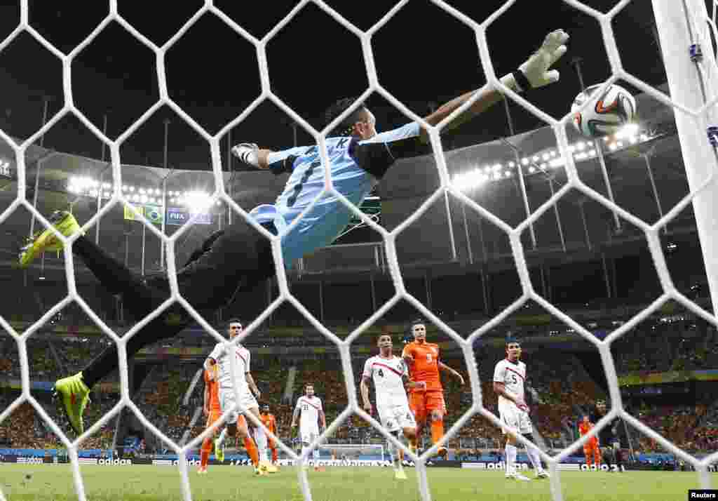 Costa Rica's goalkeeper Keilor Navas saves a free kick by Wesley Sneijder of the Netherlands at the World Cup quarter-finals at the Fonte Nova arena in Salvador, July 5, 2014