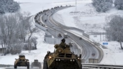 A convoy of Russian armored vehicles moves along a highway in Crimea, Jan. 18, 2022.