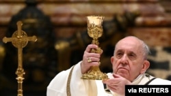 FILE - Pope Francis leads the Mass on Christmas Eve in St. Peter's Basilica amid the coronavirus disease (COVID-19) pandemic at the Vatican, Dec. 24, 2020.