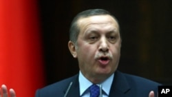 Turkey's Prime Minister Recep Tayyip Erdogan addresses lawmakers of his party at the parliament in Ankara on March 6, 2012. 